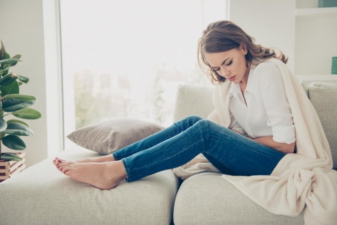 sad, upset, unhappy woman holding hands on stomach suffering from abdominal pain with close eyes, having menstrual period...