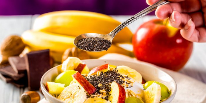 healthy breakfast with yogurt, apple, banana and chia seeds bowl of fresh fruit