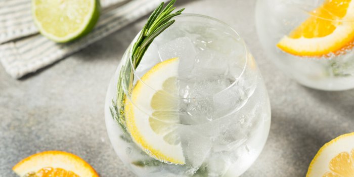 boozy refreshing hard seltzer cocktail with lemon and rosemary