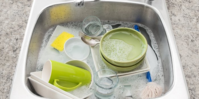 dishwashing bright dishes soaking in the kitchen sink