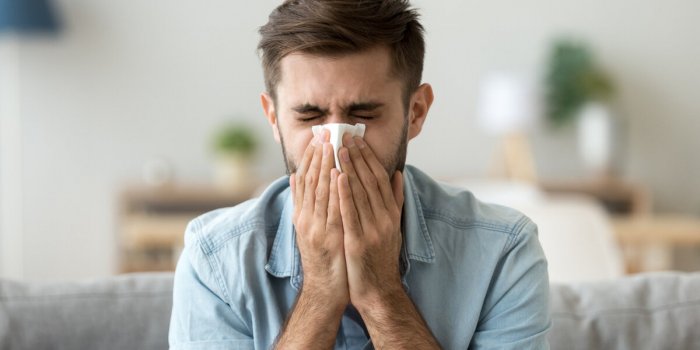 ill young man sneezing in handkerchief blowing wiping running nose, sick allergic guy caught cold got flu influenza hay f...