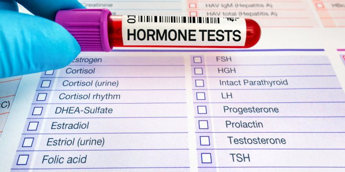 doctor holding blood tube for analysis of hormones in biochemistry lab blood sample for study of levels of hormone tests