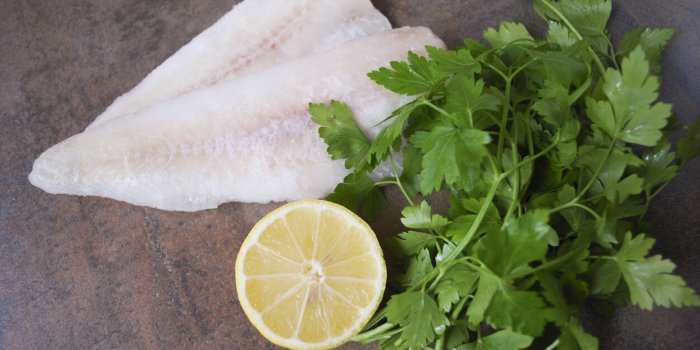 frozen alaska pollock fillet with lemon and parsley preparation for cooking