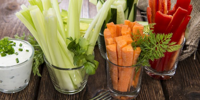 fresh vegetables in clear glasses and white dip