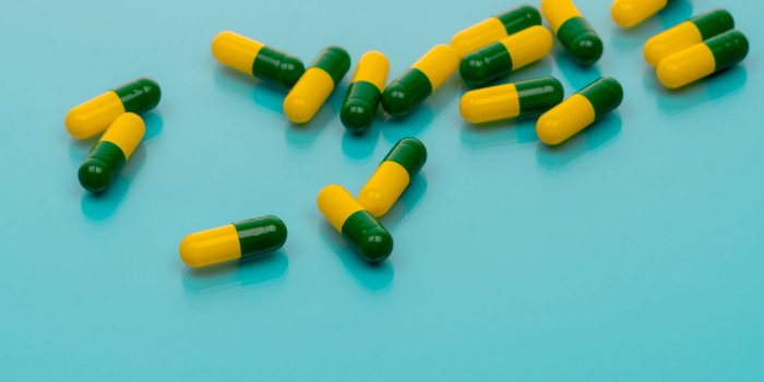 green-yellow capsules spread on blue background tramadol capsule pills for relieve severe cancer pain painkiller medicine...