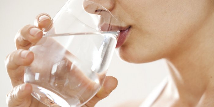 young woman drinking glass of water