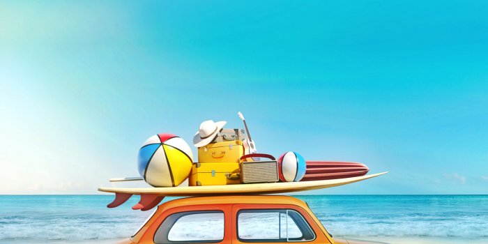 small retro car with baggage, luggage and beach equipment on the roof, fully packed, ready for summer vacation, concept o...