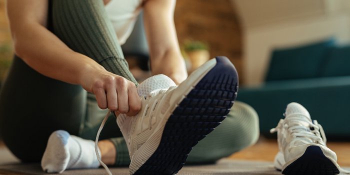 close-up of athletic woman putting on sneakers