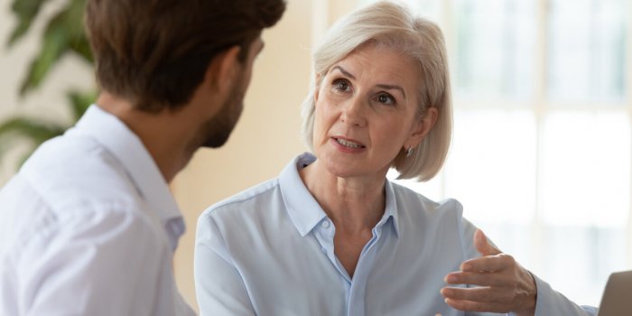 concentrated diverse businesspeople talk brainstorm at meeting in office share thoughts, focused man and woman colleagues...