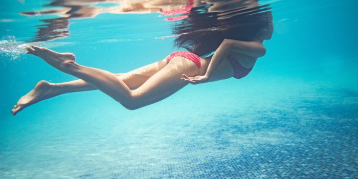 asian women are diving at the pool she was wearing a bikini