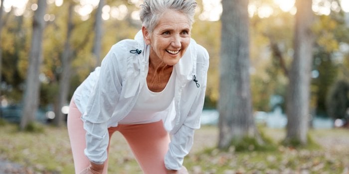 tired, happy and senior woman running in outdoor nature park for retirement health, wellness and fitness workout healthca...