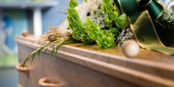 a coffin with a flower arrangement at a mortuary