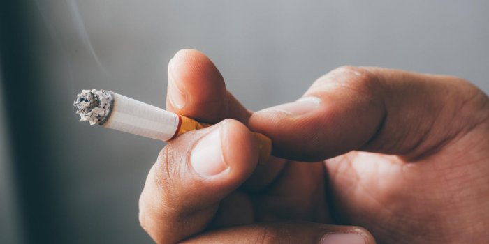 smoking cigarettes tobacco close up in hand with a soft-focus concept no quit cigarettes are dangerous to health