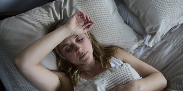 menopausal mature woman suffering with insomnia in bed at home