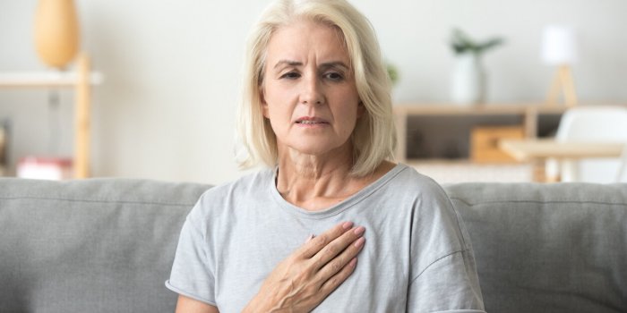 upset stressed mature middle aged woman feeling pain ache touching chest having heart attack, sad worried senior older la...